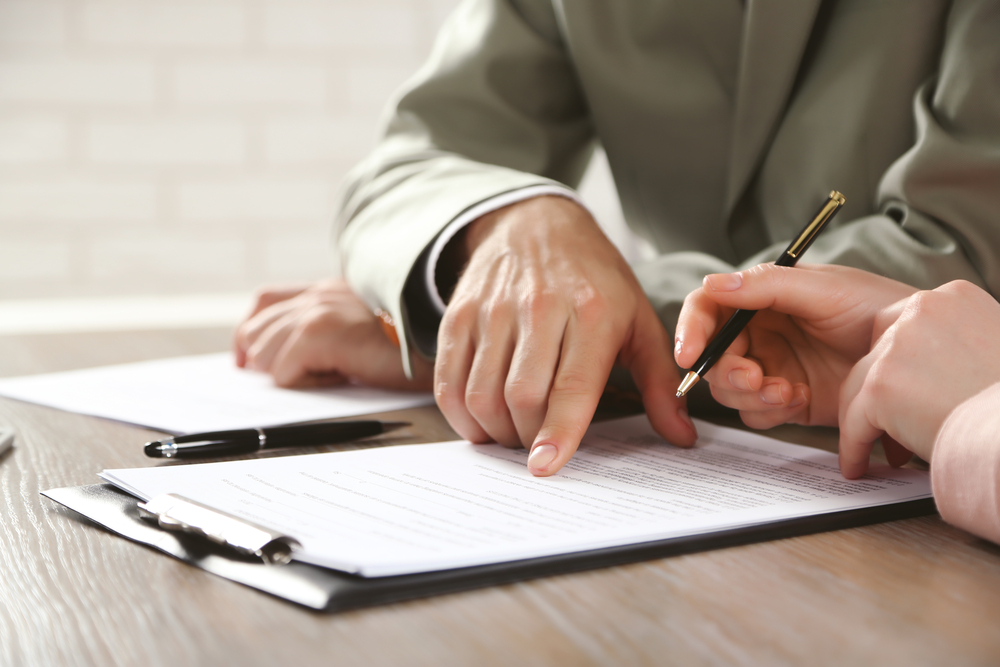 Human,Hands,Working,With,Documents,At,The,Desk,Closeup